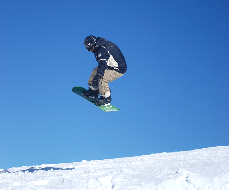 Snowboarder mit Snowboardhelm Trick
